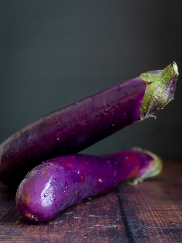 2 Asian eggplant on a wooden board.