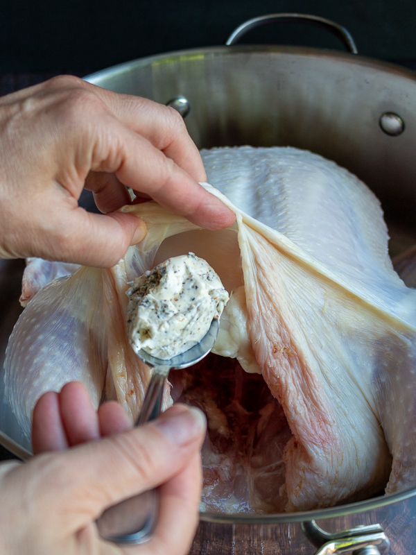 Spoonful of herbed butter ready to get stuffed under the breast skin. 