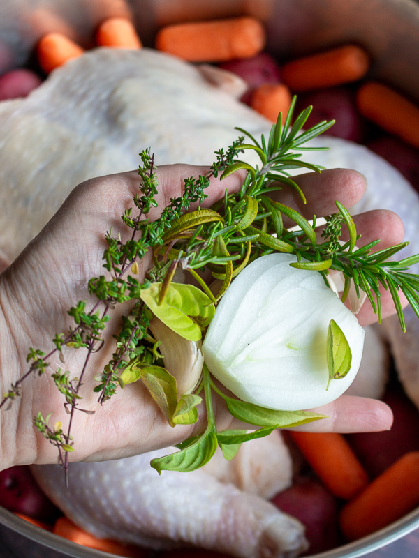 Handful of fresh herbs and aromatics ready to stuff in the chicken cavity.