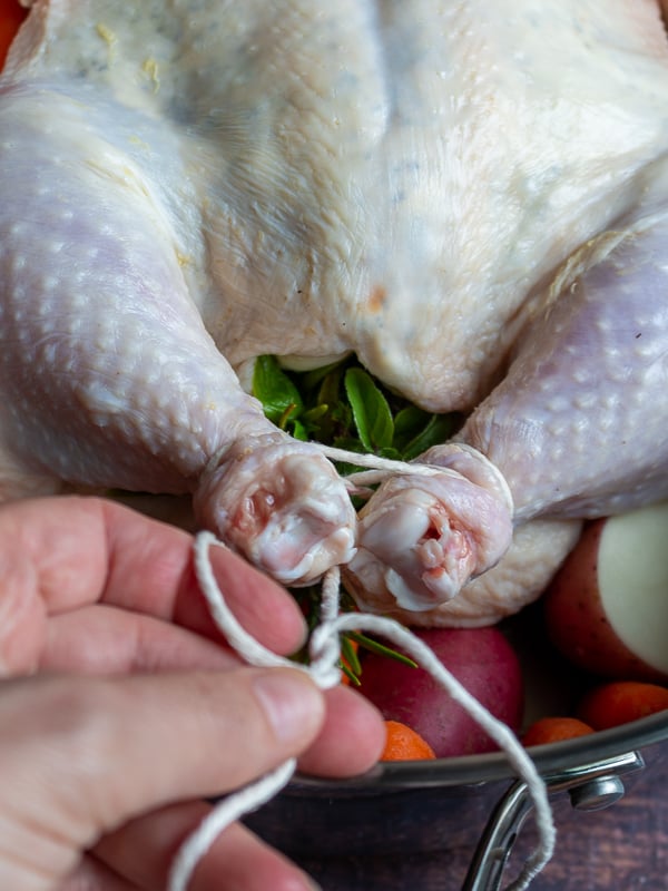 Truss the chickens legs together with butchers twine.