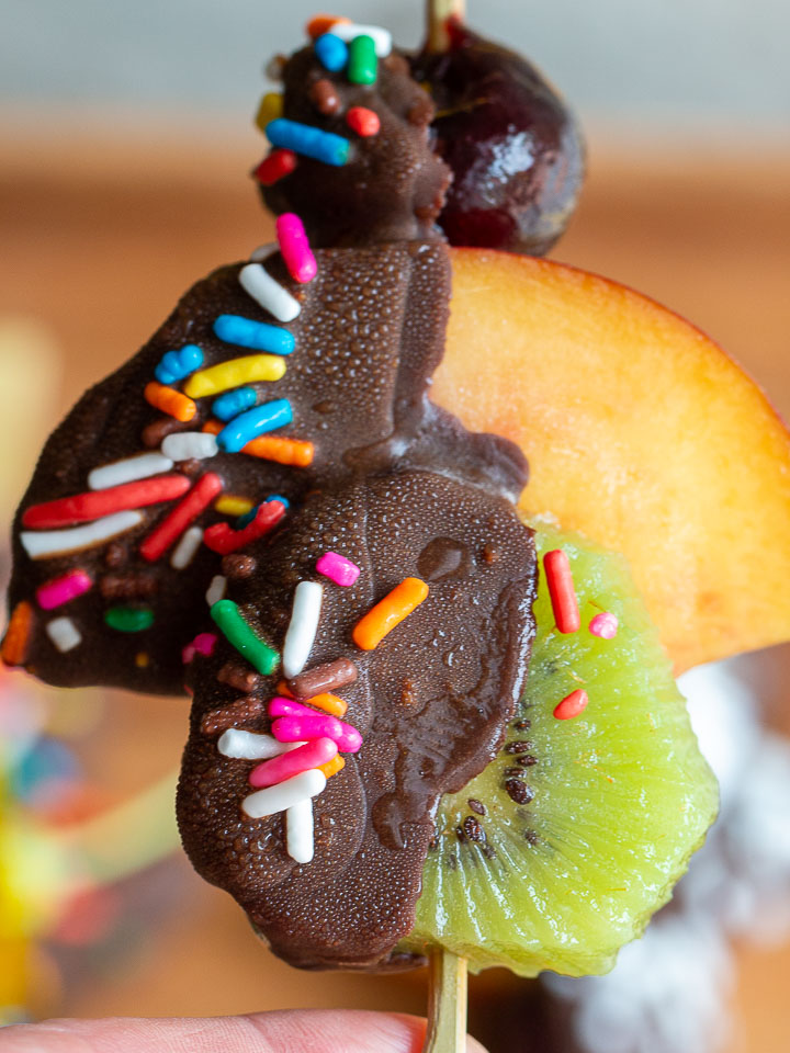 Homemade magic shell covered kiwi, nectarine and cherry with sprinkles. 