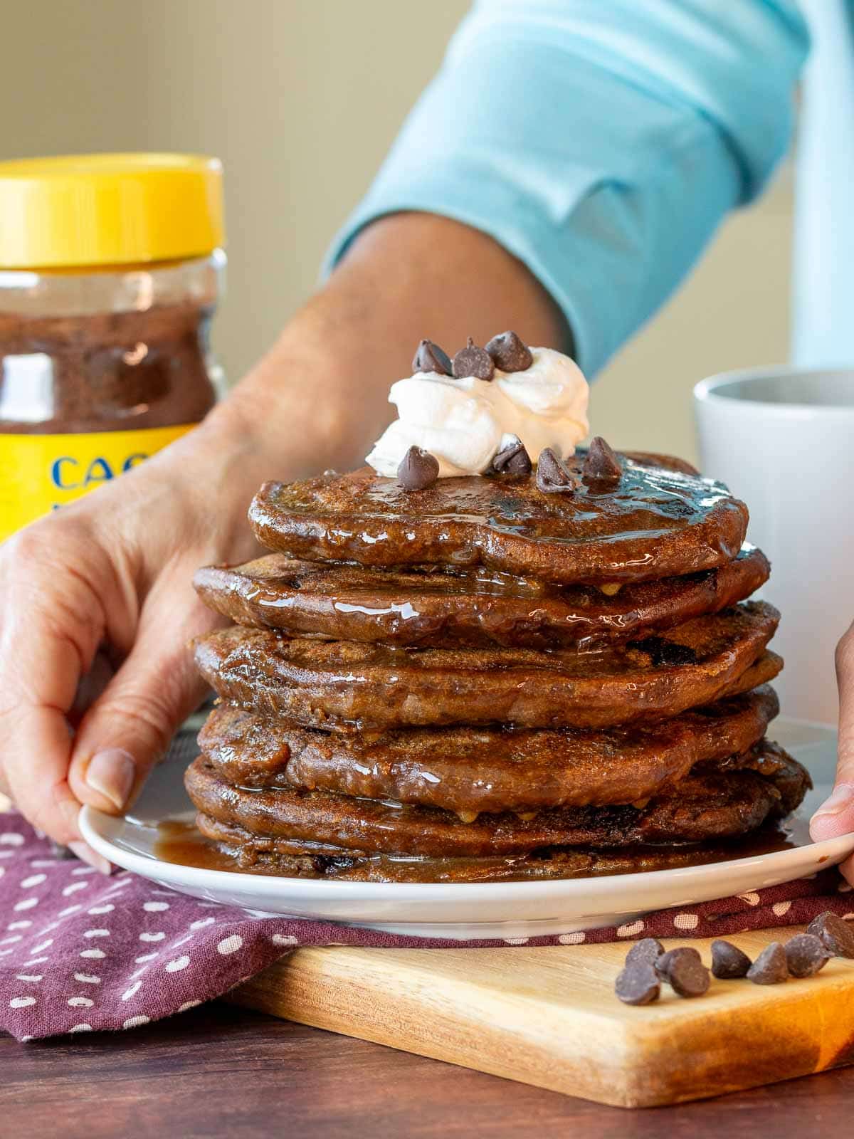 Huge stack of pancakes getting served up. 