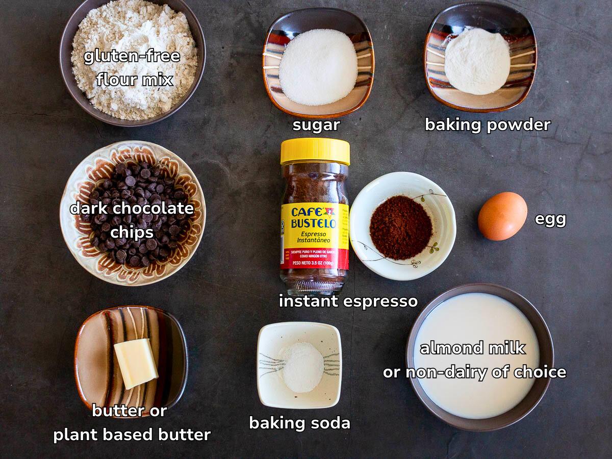 Ingredients to make gluten free pancakes with instant espresso powder laid out on a grey table. 