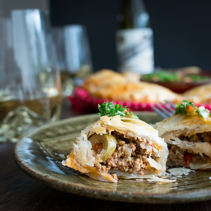 Empanadas on a green plate.