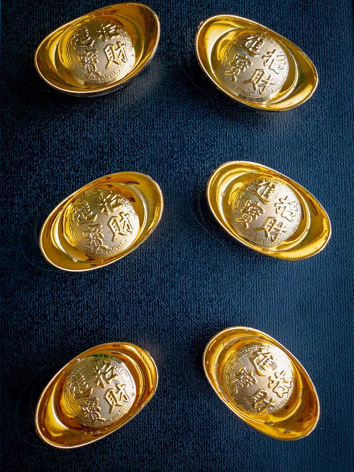 small gold ingots on a black background.