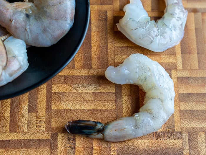 Raw shrimps getting peeled.