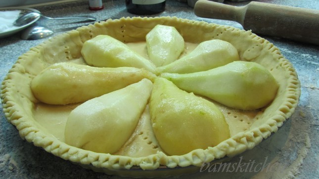 Halved peeled Pears placed inside the tart shell.