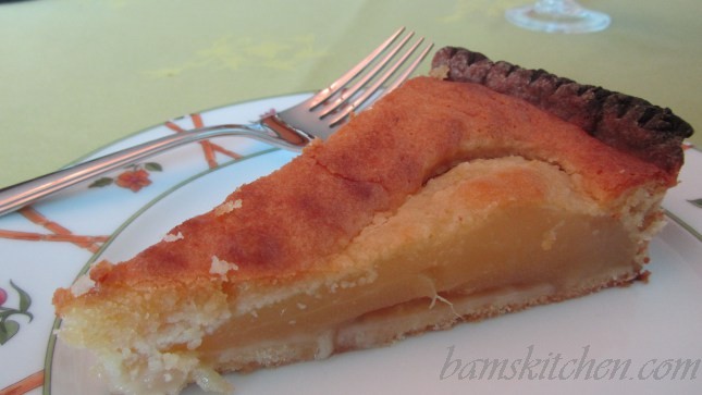 Pear and Almond Tart on a white dish with a fork.