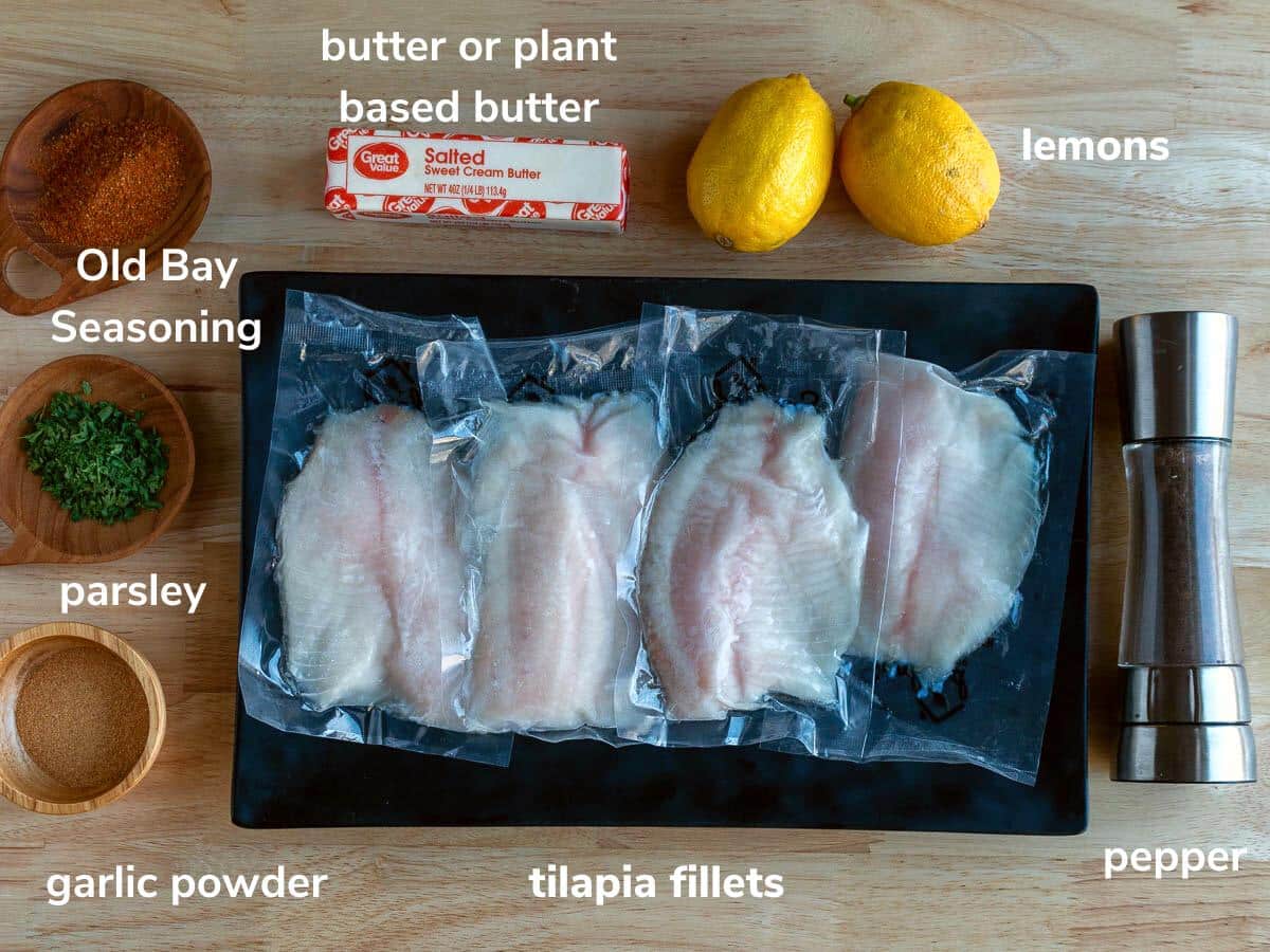 Ingredients for tilapia recipe and butter garlic sauce for seafood on a wooden table.