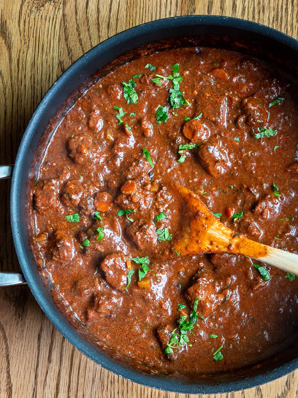 Pot of Tuscan Slow Cooked Braised Beef in Wine Sauce from the stove top.