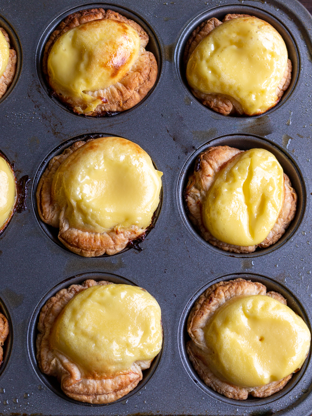 Egg tarts that puffed after baking.