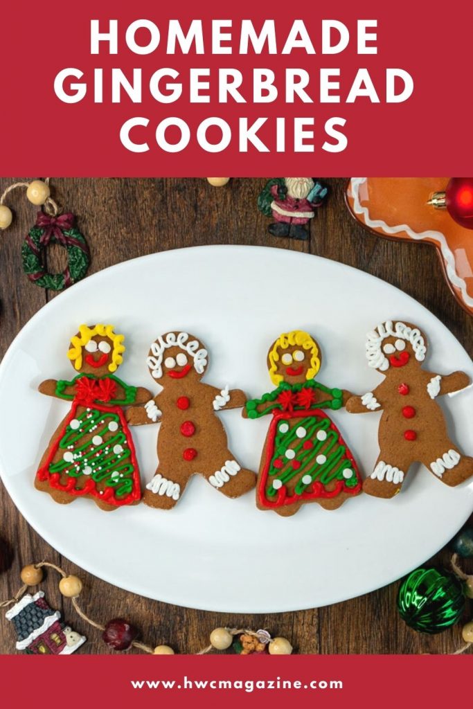 Homemade Gingerbread Cookies decorated with royal icing on a white plate all holding hands.