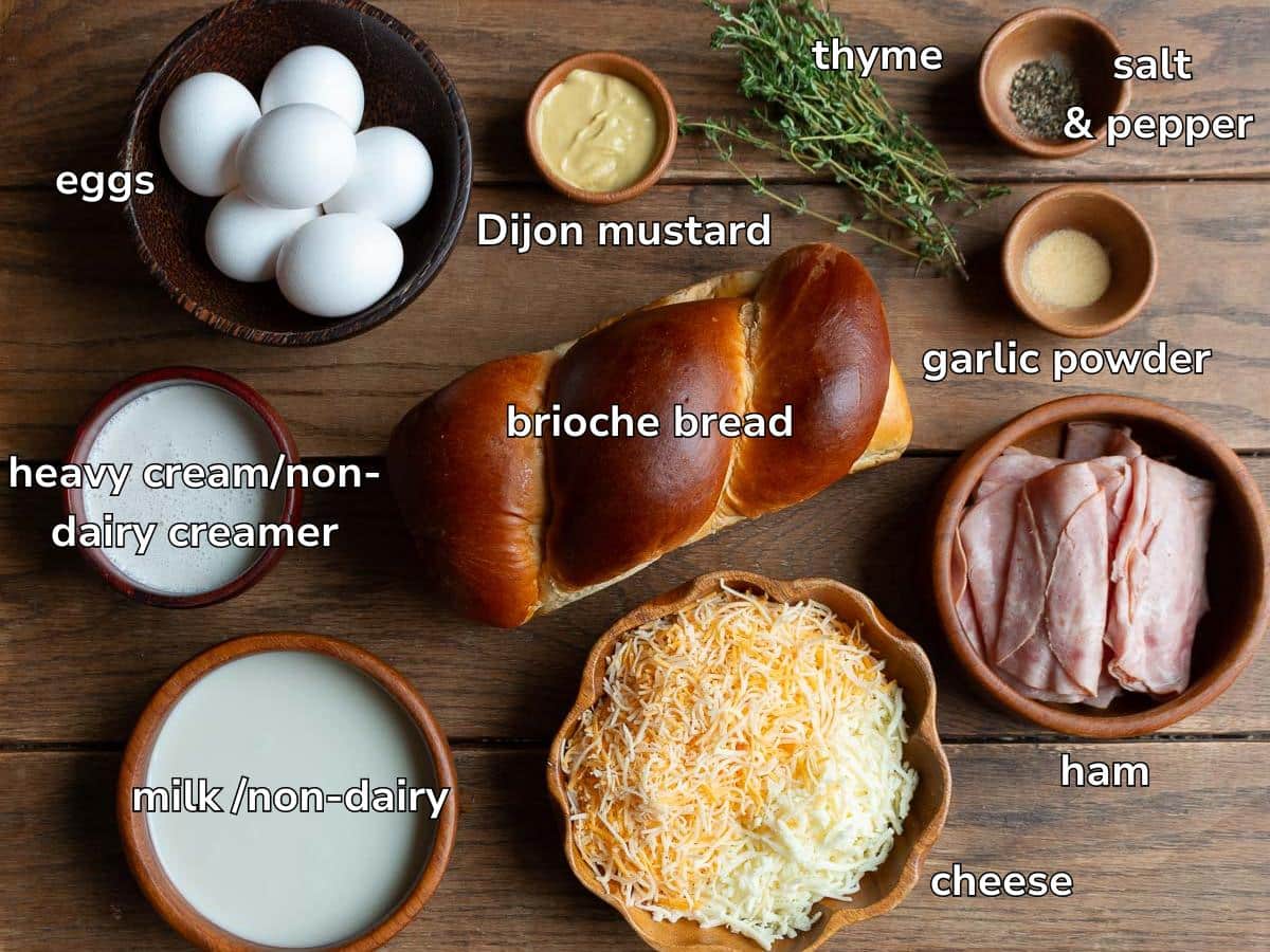 Ingredients to make ham and cheese egg casserole laid out on a wooden board. 