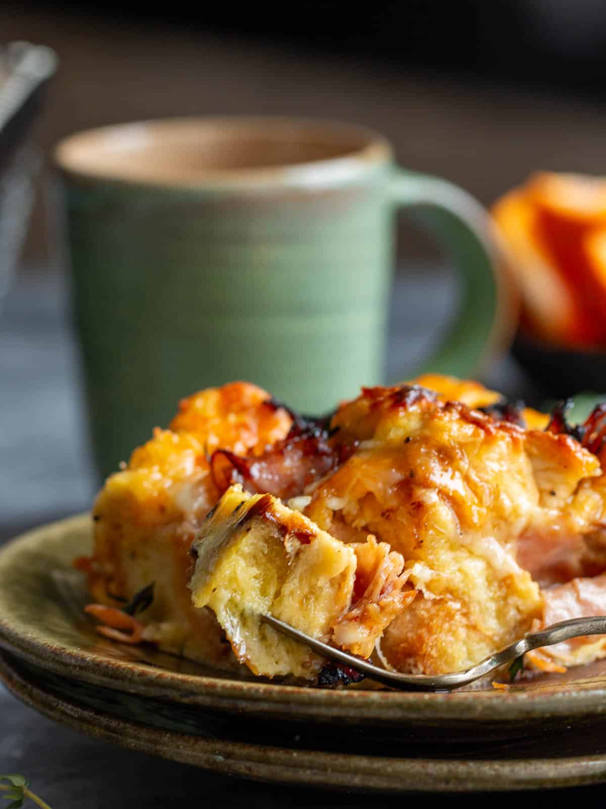 Taking a bite out of a slice of the layered egg bake. 