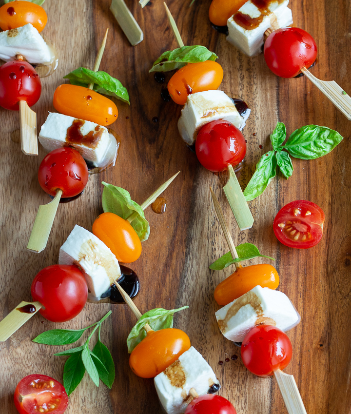 Super cute caprese salad on a stick drizzled with balsamic and EVOO.