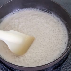 Coconut Sauce bubbling and reducing on the stove.