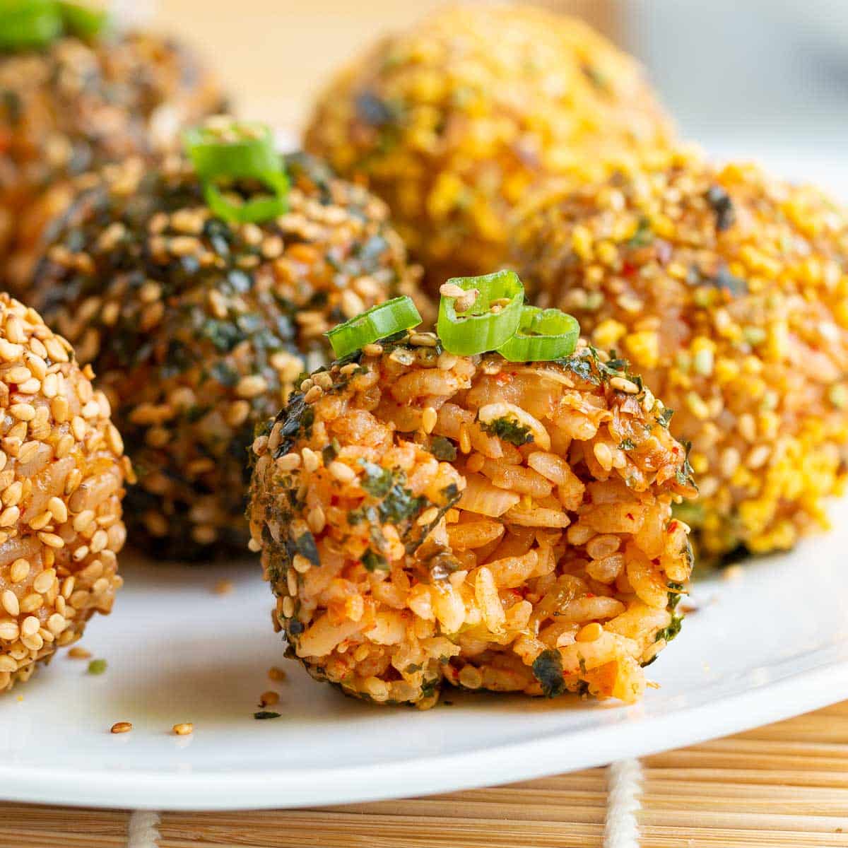 A bite taken out of a rice balls showing the filling.