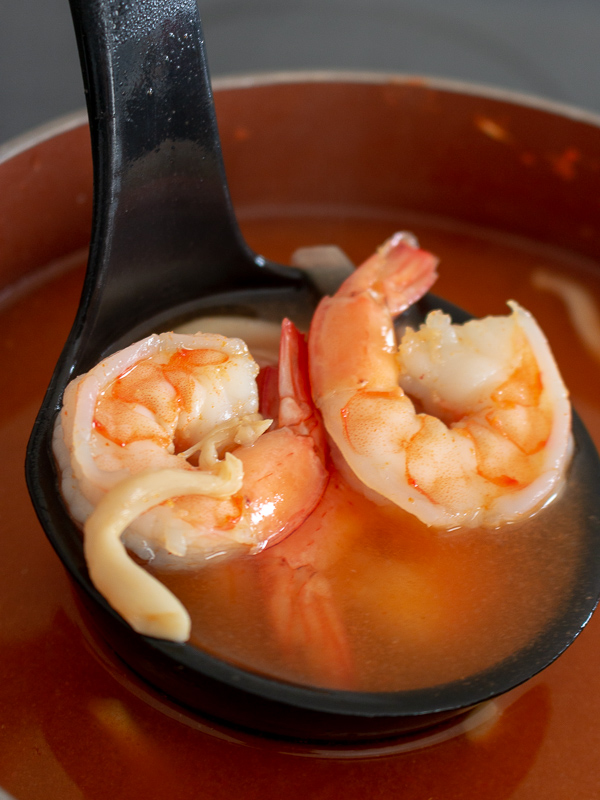 Soup ladle of shrimp and soup broth.