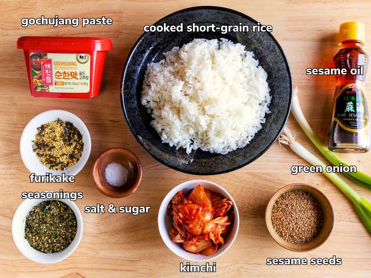 Ingredients to make Korean rice balls laid out on a wooden table.