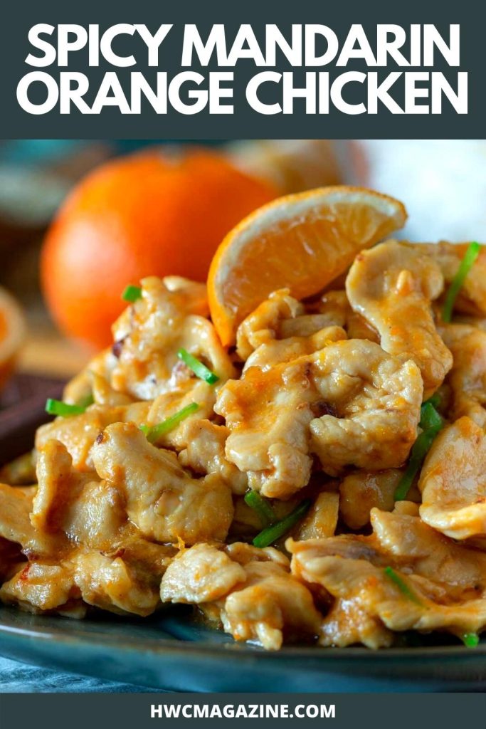 Spicy mandarin orange chicken showing the velvety tender chicken and orange sauce. on a blue plate.