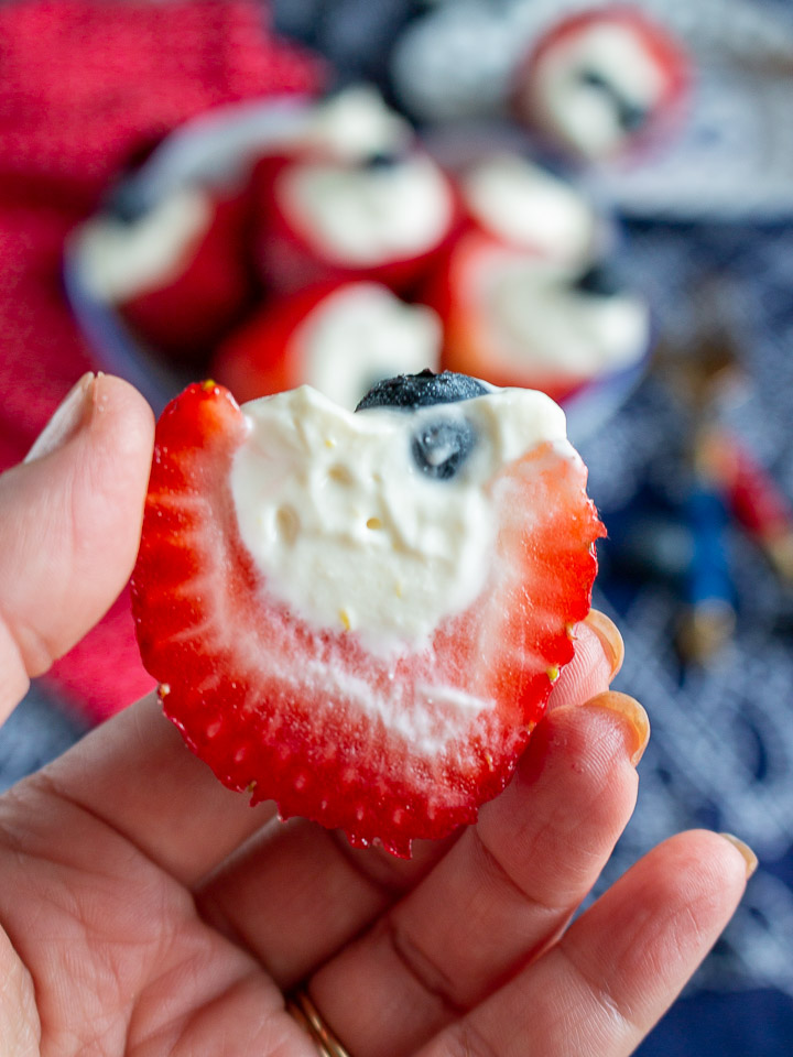 A stuffed strawberry cut in half to show the filling.