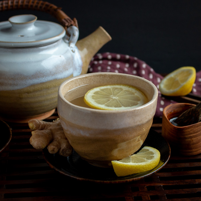 Lemon Ginger Tea garnished with lemon wedges.