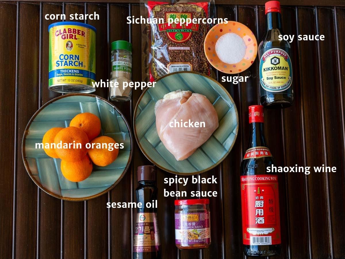 Ingredients for mandarin orange chicken laid out on a wooden board.