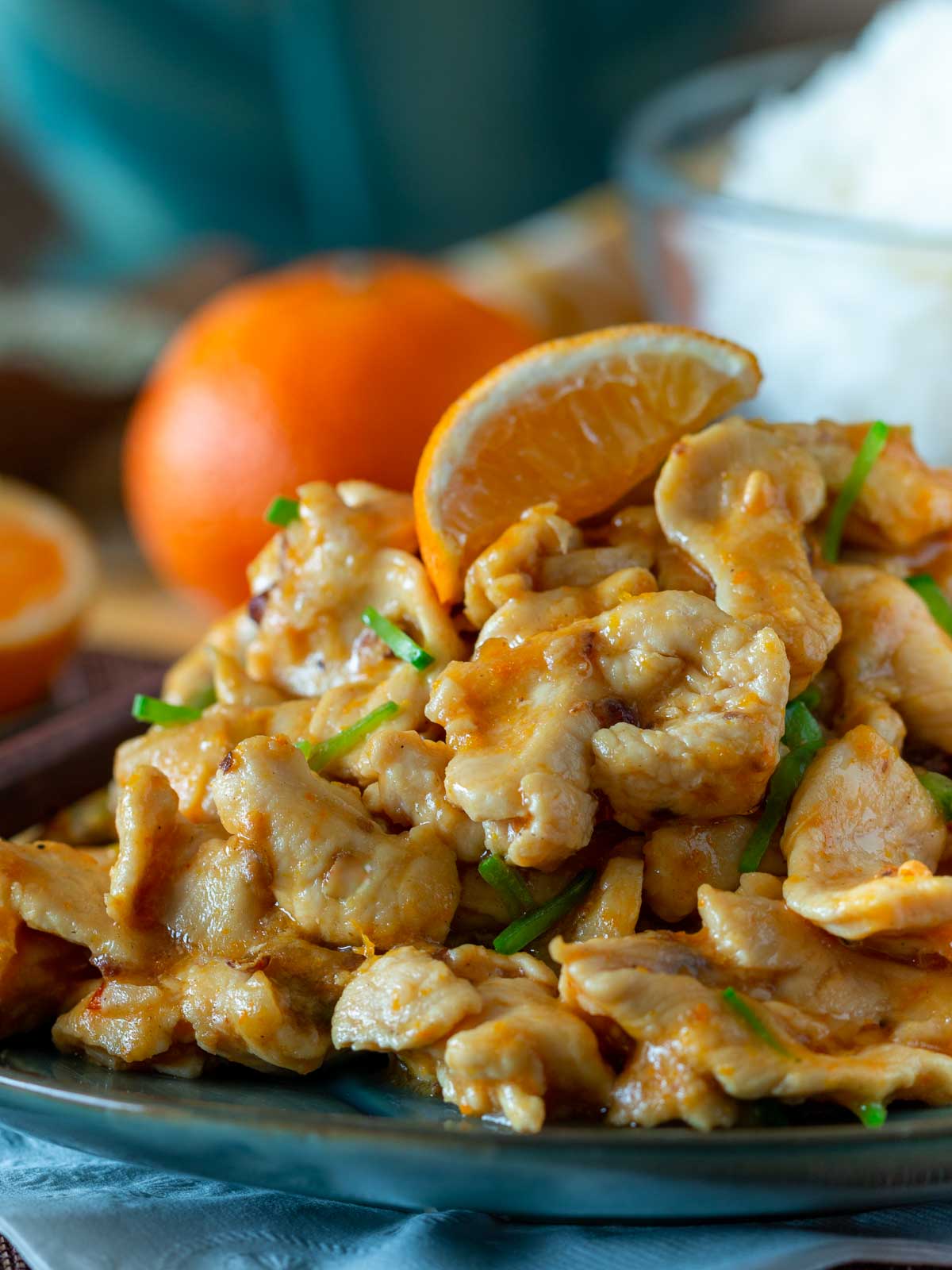 Close up of the tangerine chicken showing the glossy orange sauce and tender chicken pieces.