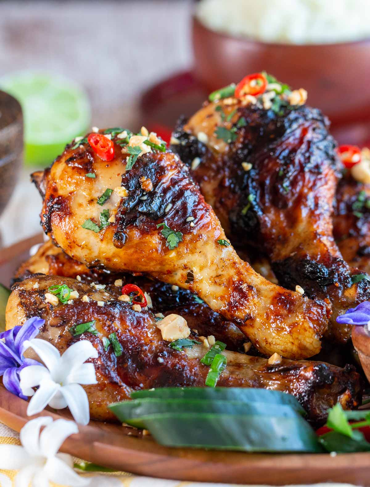 Air Fryer Crispy Curry Chicken Legs garnished with peanuts and chilis.