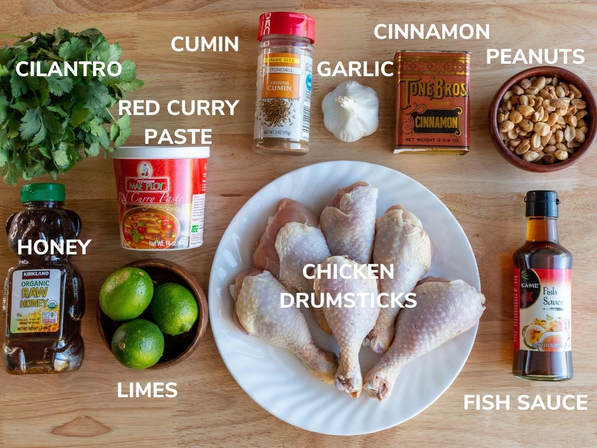 Ingredients to make air fried chicken drumsticks on a wooden board.