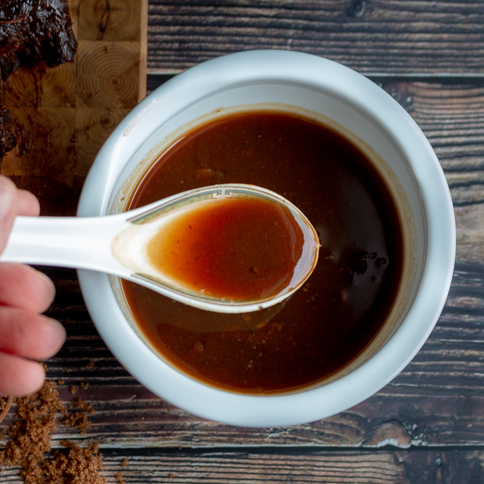Pad Thai sauce in a white spoon.