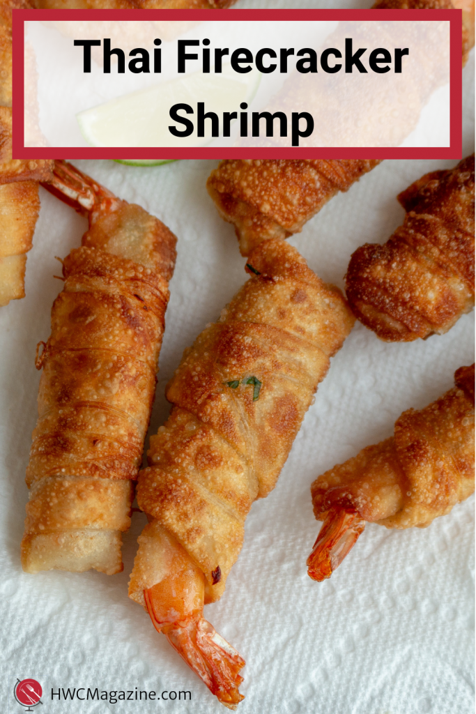 Thai Firecracker Shrimp Party Appetizer is a deliciously marinated shrimp with the tail on, bundled in a spring roll wrapper and pan fried until golden. Served with a Prik Nam Pla dipping sauce. #thai #qppetizer #shrimp #springrolls #firecracker #asian #easyrecipe #eattheworld / https://www.hwcmagazine.com