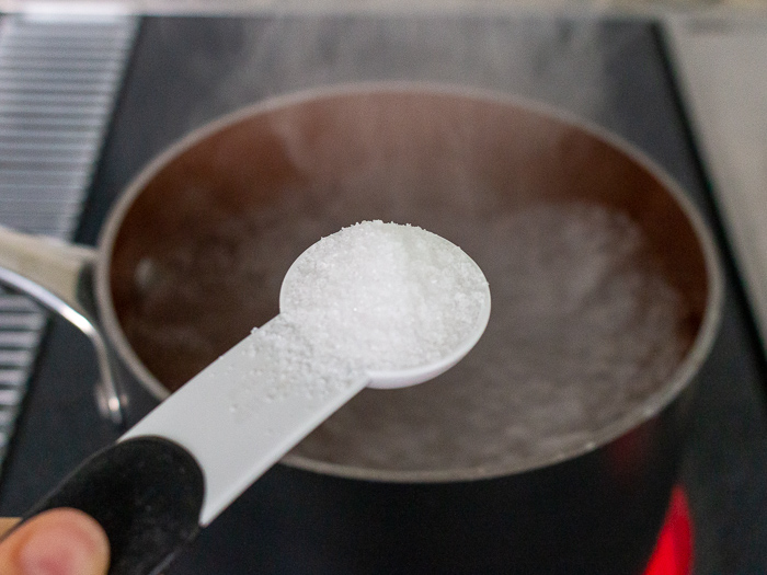 Salting the pasta water.