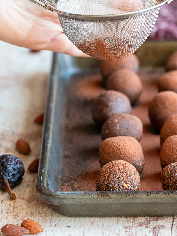 Cocoa powder getting dusted over the Chocolate Espresso Fig Balls. 