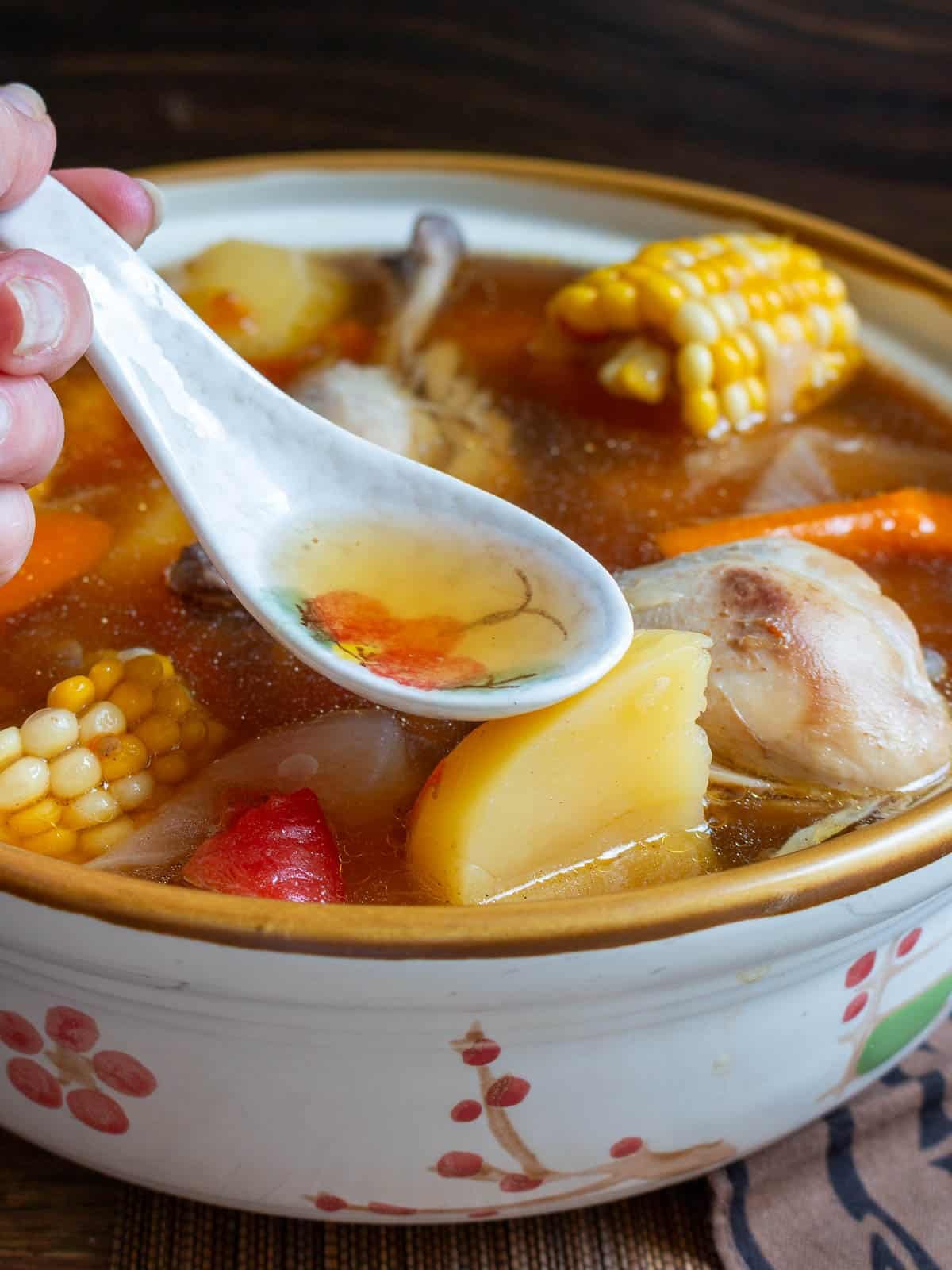 Cantonese ABC soup in a Chinese Soup pot showing the clear soup broth. 