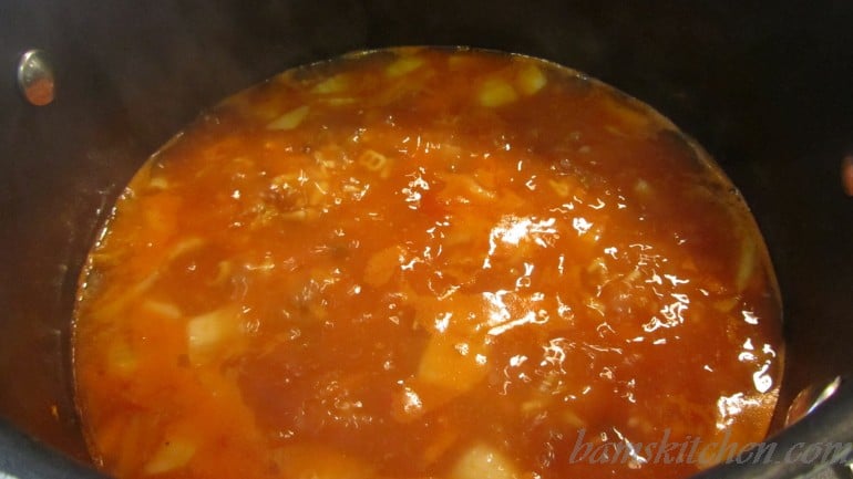 Soup cooking in a black pot- simmering...