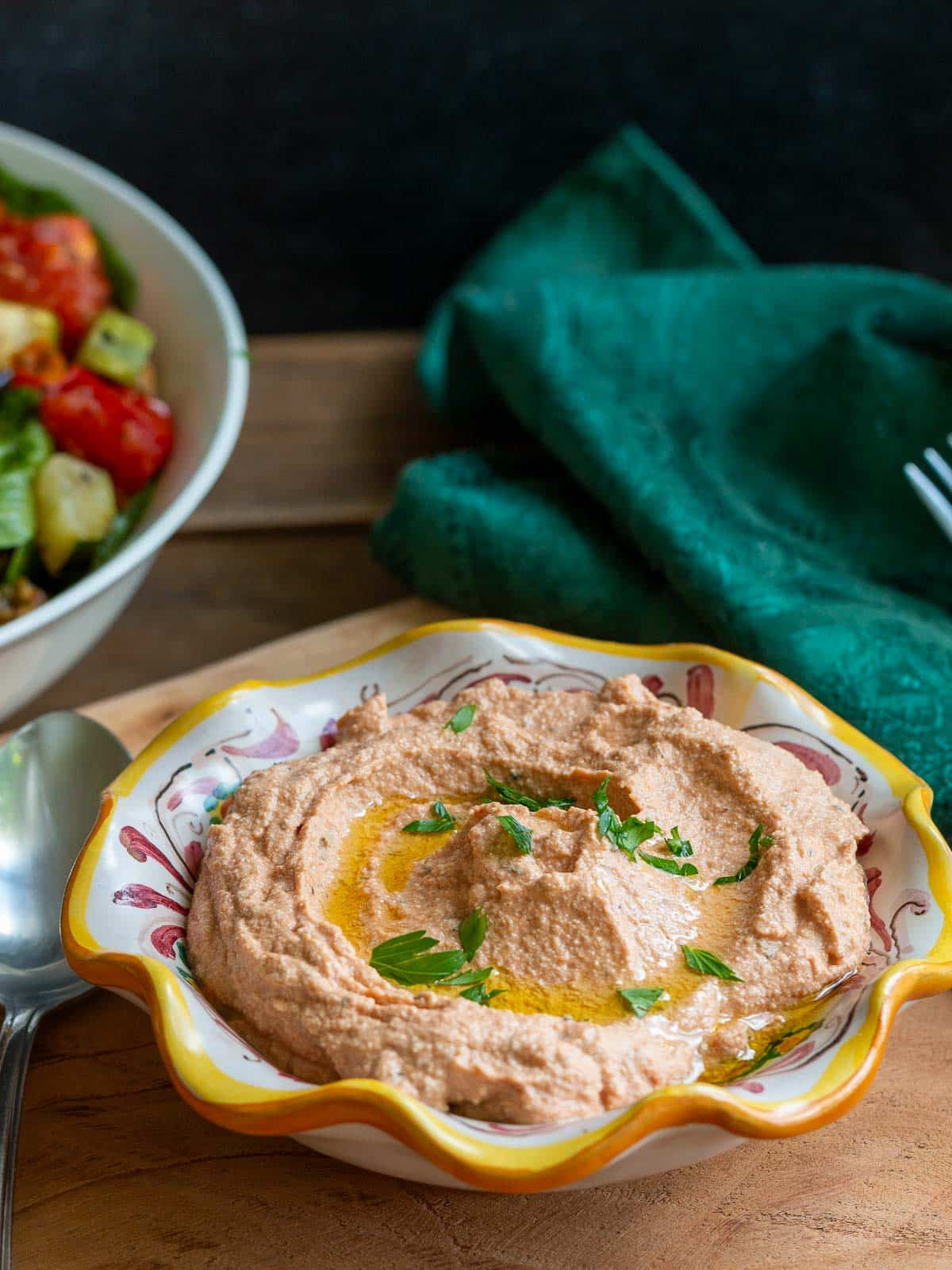 Vegan Tofu ricotta with lemon and tomato in an Italian handmade yellow pottery dish. 