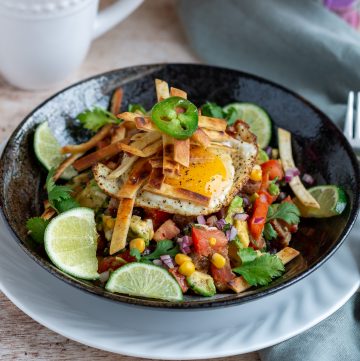 Delicious Healthy Tex Mex Breakfast Bowl garnished with lime and cilantro and crispy tortilla strips.