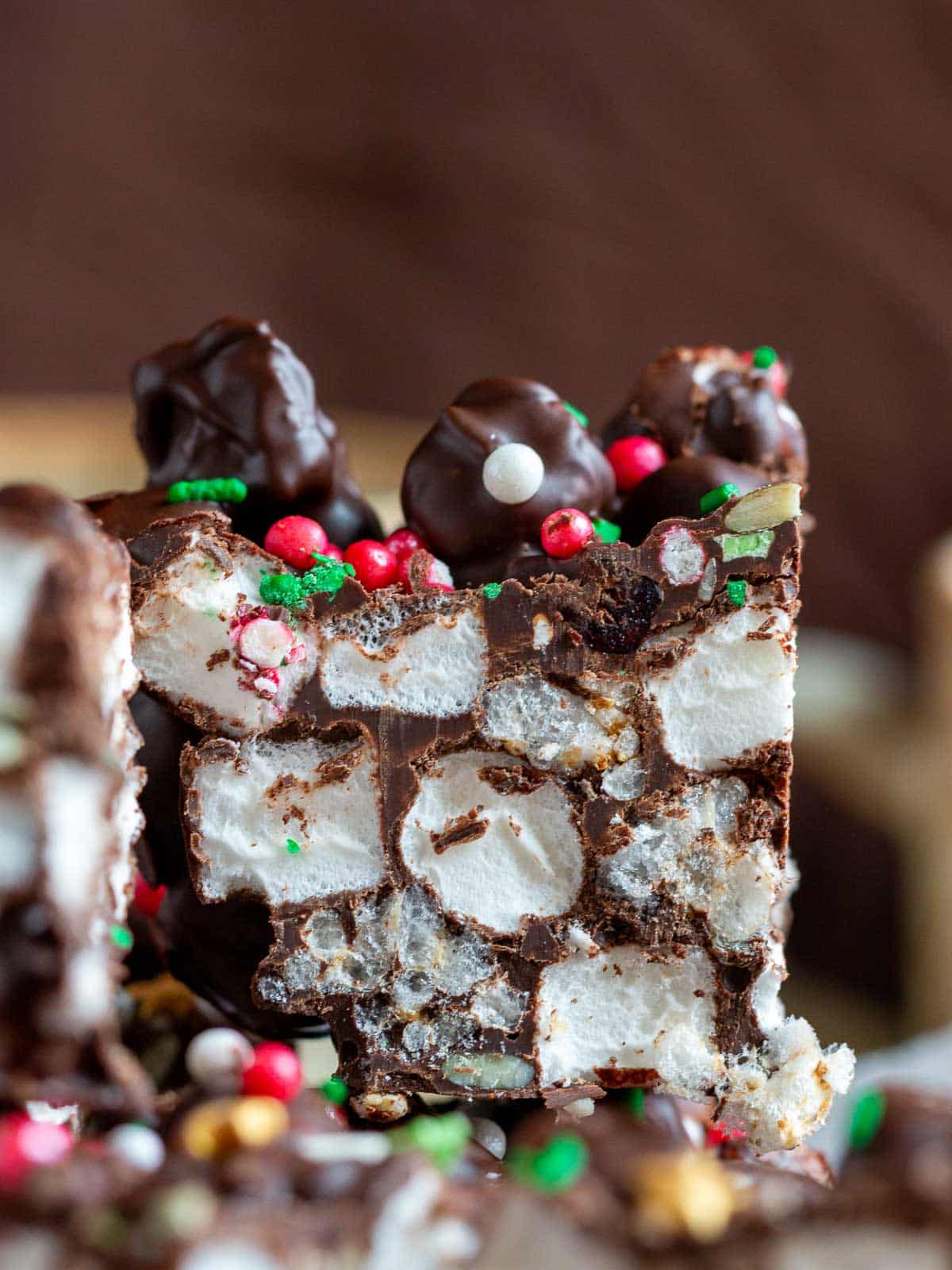 Rocky road bar sliced showing the crispy rice cake pieces, marshmallows and trail mix. 