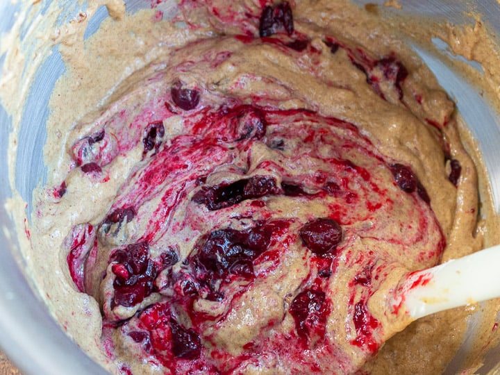 Cranberries getting mixed into batter.