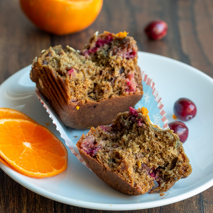 A holiday muffin cut in half to show the cranberry studded jeweled muffin.. 