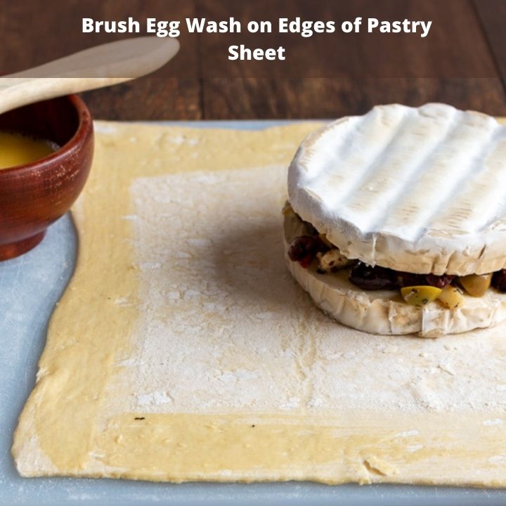 Brush sides of pastry dough with egg wash.