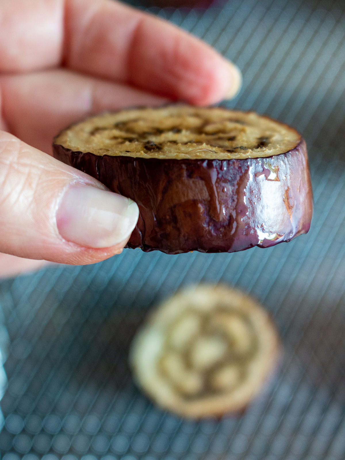 Eggplant just finished cooking in the air fryer and held in hand.