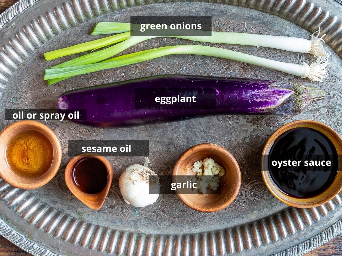 Ingredients to make eggplant appetizer on a silver platter.
