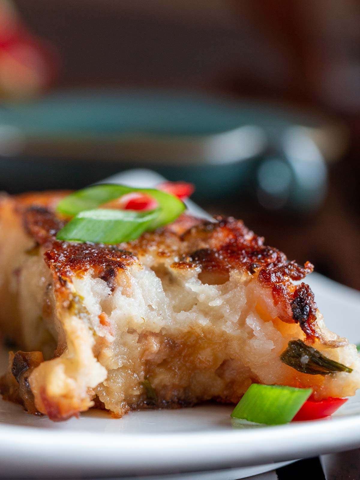 The bite shot showing the crispy edges and tender inside of the radish cake.