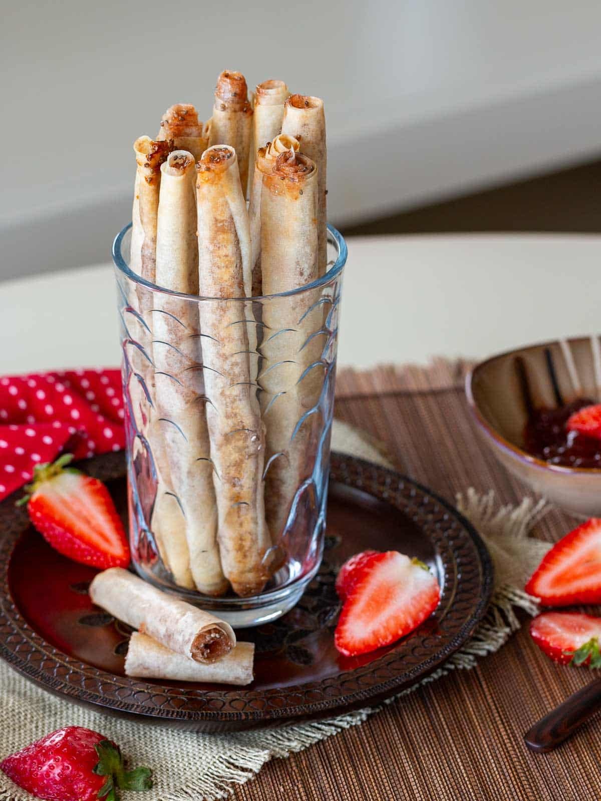 Long pirouette cookies in a tall glass.
