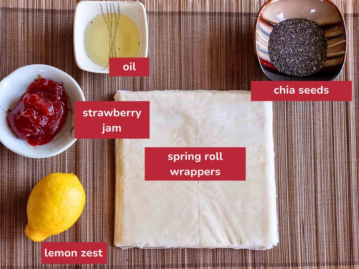Ingredients to make strawberry jam cookies laid out on a bamboo placemat.