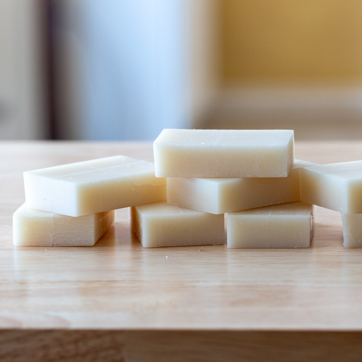 Unwrapped raw kirimochi rice cakes laying on a wooden table.