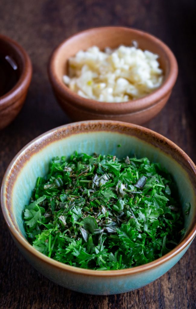 Bowl of fresh chopped herbs and garlic.