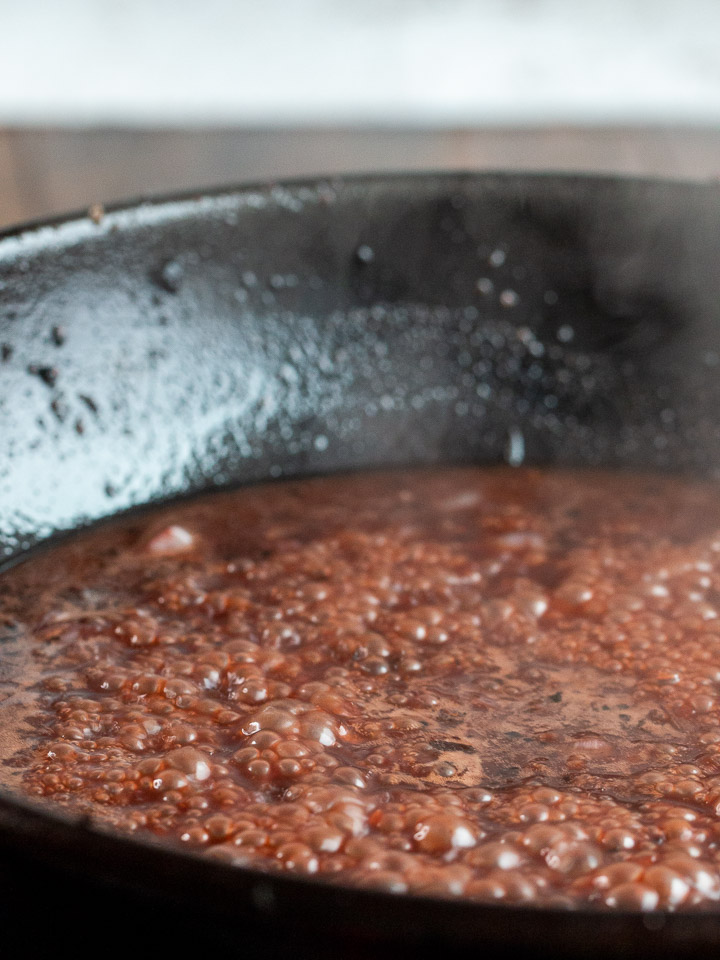 Pomegranate sauce reducing on the stove.